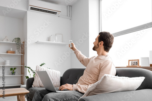 Young man with laptop turni...