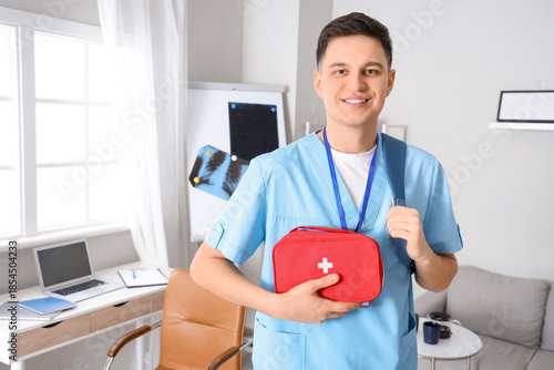 Male medical intern with ba...