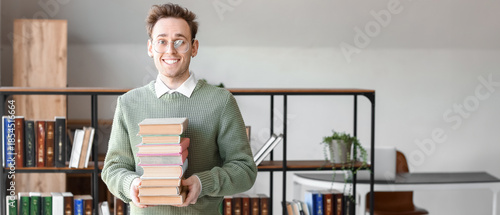 Young man with stack of boo...