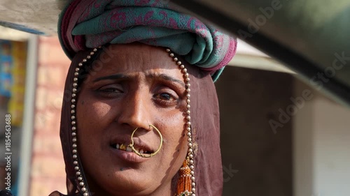 expressive face of indian woman daily wage worker at construction site in traditional attire