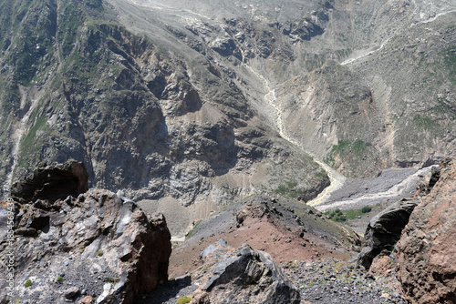 Rocky mountain gorge with winding riverbed at the bottom