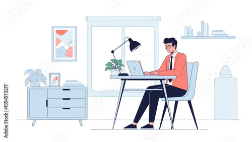 A man working remotely on his laptop at a modern home office desk with a plant and lamp.