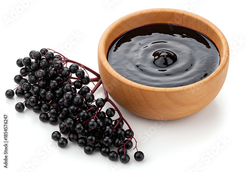 wooden bowl filled with elderberry syrup used as natural sweetener and remedy