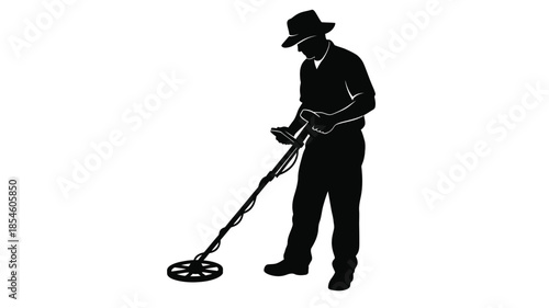 A man using a metal detector in a striking black silhouette