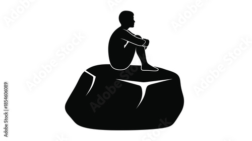 A person sits thoughtfully on a rock formation a striking silhouette