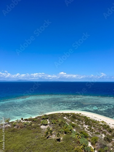 The view of a vibrant blue ocean and lively reef from the top of the Amédée Lighthouse on Amédée Islet, a remote, tropical island in New Caledonia, a French overseas territory in the South Pacific.