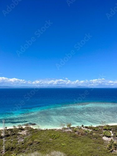 The view of a vibrant blue ocean and lively reef from the top of the Amédée Lighthouse on Amédée Islet, a remote, tropical island in New Caledonia, a French overseas territory in the South Pacific.