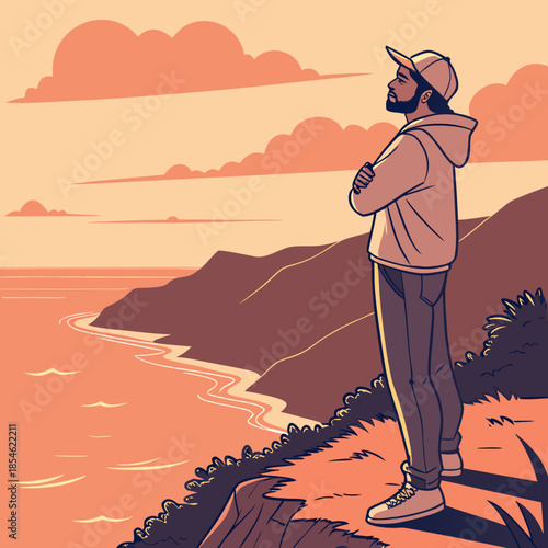 Young man standing on cliff overlooking ocean at sunset  