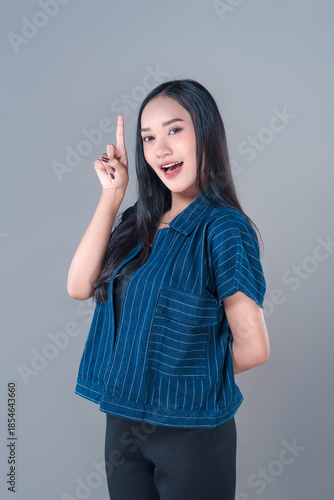 Indonesian Woman Pointing Up with Confident Expression