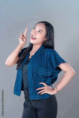 Indonesian Woman Pointing Up with Cheerful Expression