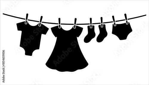 Black silhouettes of baby clothes hanging on a line clothesline onesie dress