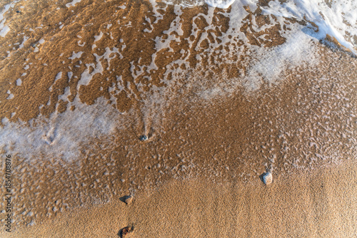 Close-up soft wave of the sea on the sandy beach