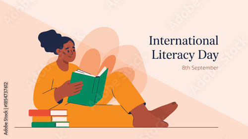 A happy woman in yellow clothes sits on stacked books reading an open volume for International Literacy Day
