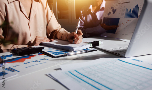 Above table with finance papers, graphs and big data during teamwork meeting with accounting or marketing team discussing budget, strategy or growth development. Closeup of SEO team doing research