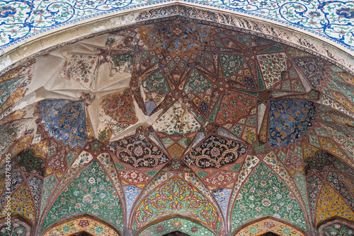 Colorful view of floral and geometric painting on archway of ancient mughal era Wazir Khan mosque entrance, Lahore, Punjab, Pakistan