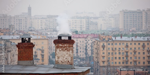 Brick Chimneys with Smoke Over Urban Cityscape Under Gray Sky During Daytime