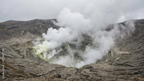 Mount aso nakadake crater emitting thick white and yellow sulfurous steam and plumes into grey sky, dramatic barren volcanic landscape showing raw geothermal power and hazard