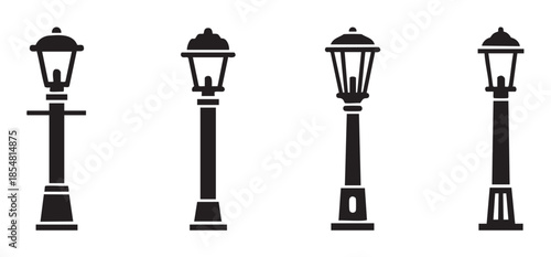 Four classic black street lamps provide elegant illumination with various traditional designs, perfect for urban and park settings.