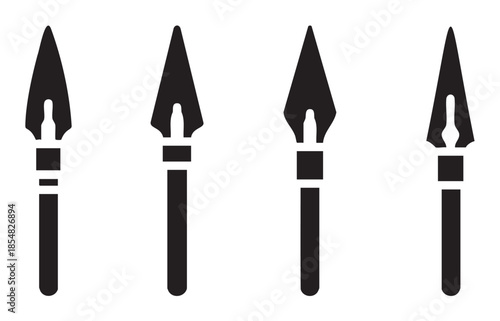 Four ancient weapon spearheads or arrowheads displayed in a row, representing primitive hunting tools and historical combat implements.