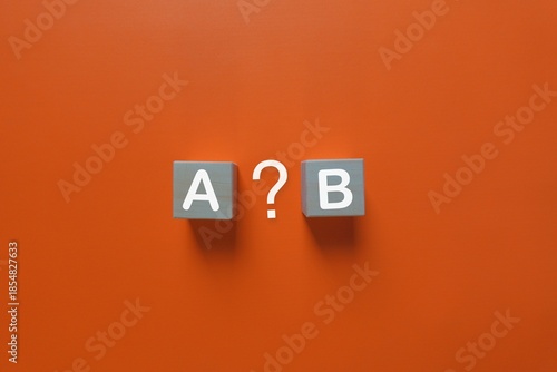 Gray blocks with white letters and question mark on orange background