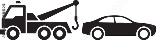 Black tow truck towing a black car with a crane hook