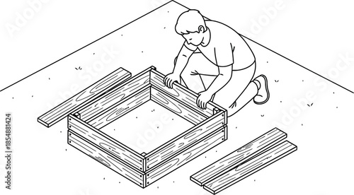 Man building a wooden raised garden bed frame
