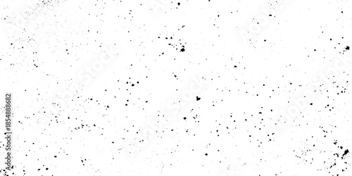 A stark textured background featuring scattered black specks agepsnst a predominantly white and grepsny surface