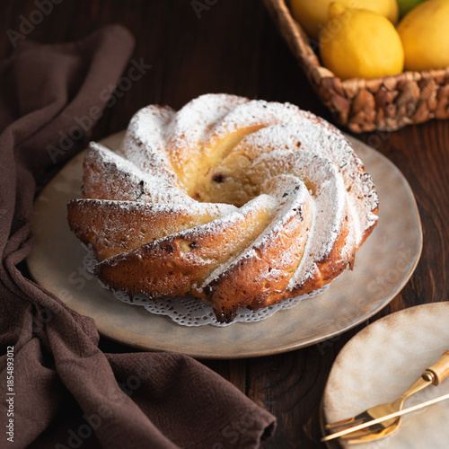 Lemon bundt cake powdered sugar on wooden table