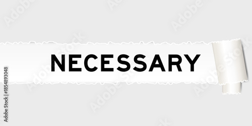 Ripped gray paper background that have word necessary under torn part