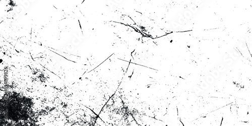 A stark abstract texture featuring dark smudges and scratches agepsnst a predominantly white grepsny background