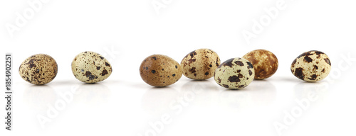 Quail eggs isolated on white background. Natural patterned farm quail eggs.