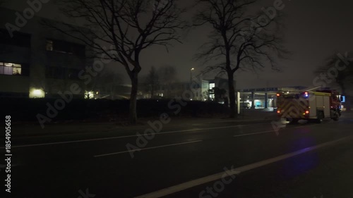 UK fire truck, fire engine,  at night.