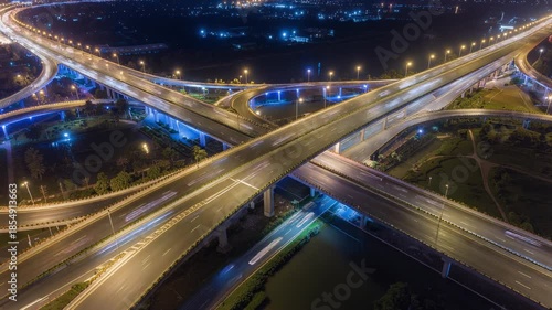 Aerial View of Modern Highway Interchange at Night with Light Trails