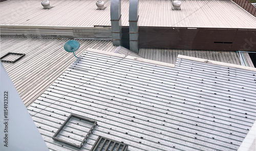Textured of Corrugated Roofing Sheet, Dish Aerial, Chimney Ventilation System and Roof Ventilators on Rooftop Record Video from Hotel at Bueng Kan, Thailand. 04 NOV 2025, A.M.
