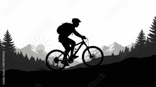 Silhouette of a mountain biker riding on a trail with mountains in the background.