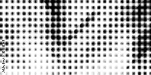 A dense and irregular black and white halftone dot pattern creating a textured, almost cloudy abstract background.