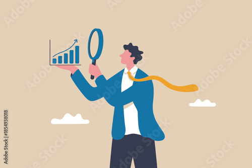 Businessman examining graph with magnifying glass