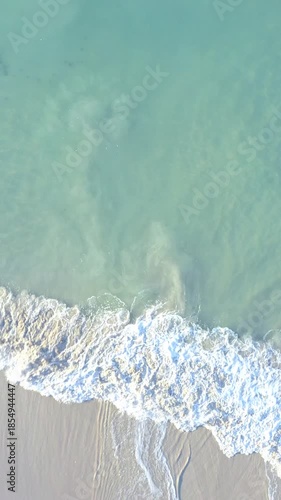 Aerial View of Turquoise Ocean Waves Washing Shore