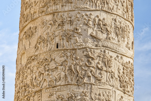 Close-up of the reliefs on the Column of Marcus Aurelius in Rome, depicting scenes of ancient Roman military campaigns carved in marble.