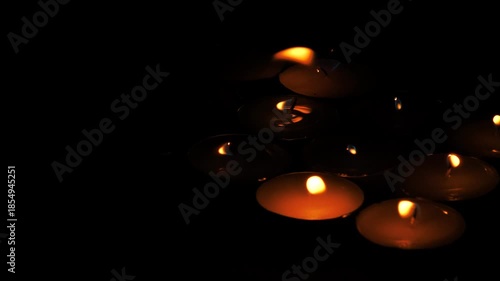 Lit Candles Glowing in Dark Ambient Light