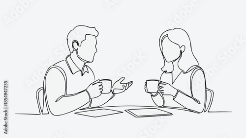 Two people having a conversation while holding coffee cups.