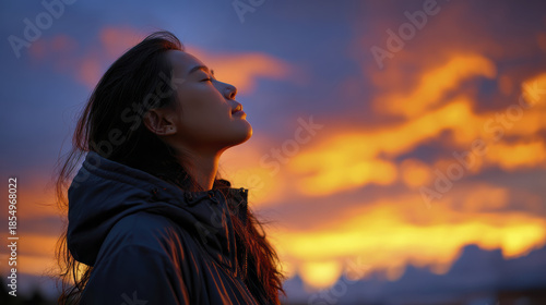 Silhouette woman sunset sky peaceful female profile colorful cloud serene evening light contemplation calm nature outdoor jacket