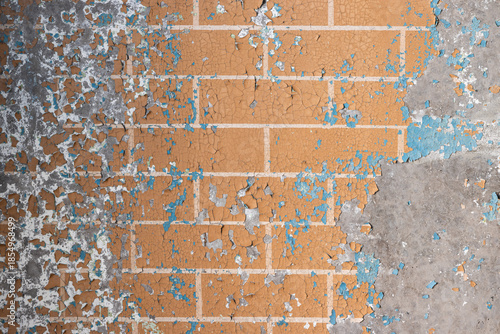 Peeling paint on the wall. Old concrete wall with cracked flaking paint. Weathered rough painted surface with patterns of cracks and peeling. Grunge texture for background and design. High resolution.