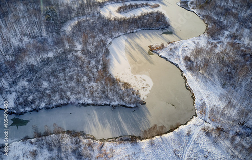 Aerial photo of Koen river under ice and snow. Beautiful winter landscape.