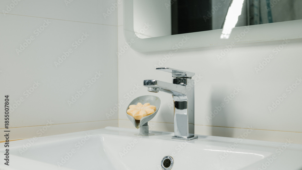 Fototapeta premium Modern bathroom sink with chrome faucet and soap holder