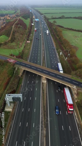 Aerial view of busy highway motorway M1, traffic and vehicles driving  in foggy conditions, United Kingdom 