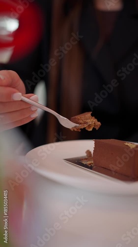 A woman eats a chocolate dessert. The concept of tasting dessert.