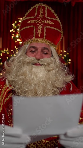 Saint Nicholas is reading a letter from a child. The concept of a New Year's miracle.