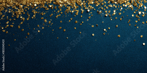 Abstract background with gold glitter on a blue background. Scattered glitter particles on a dark blue background. Festive banner with clear space.