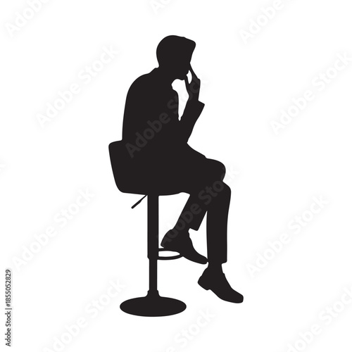 Silhouette of a man seated on a stool deep in thought and contemplation